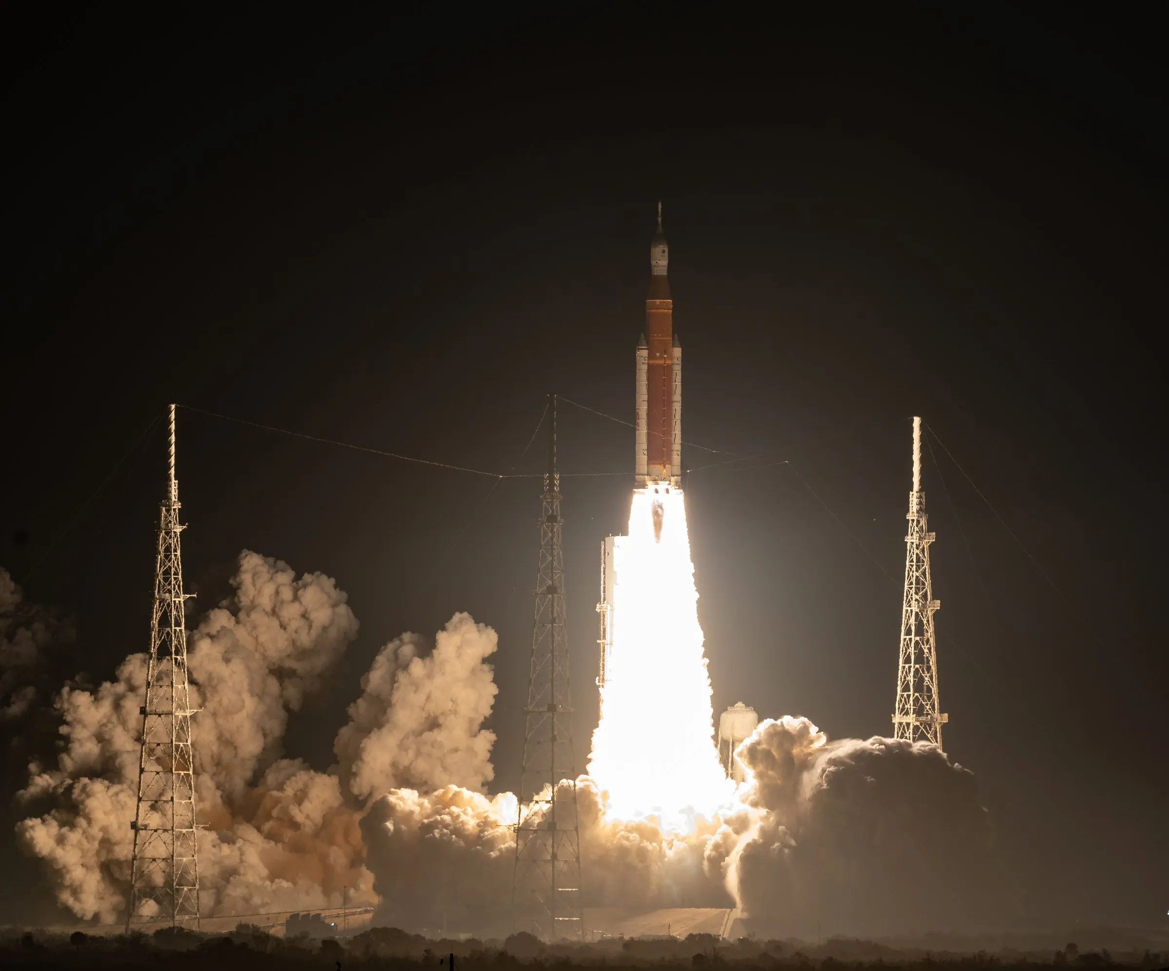 The Artemis I rocket lifting off at night.