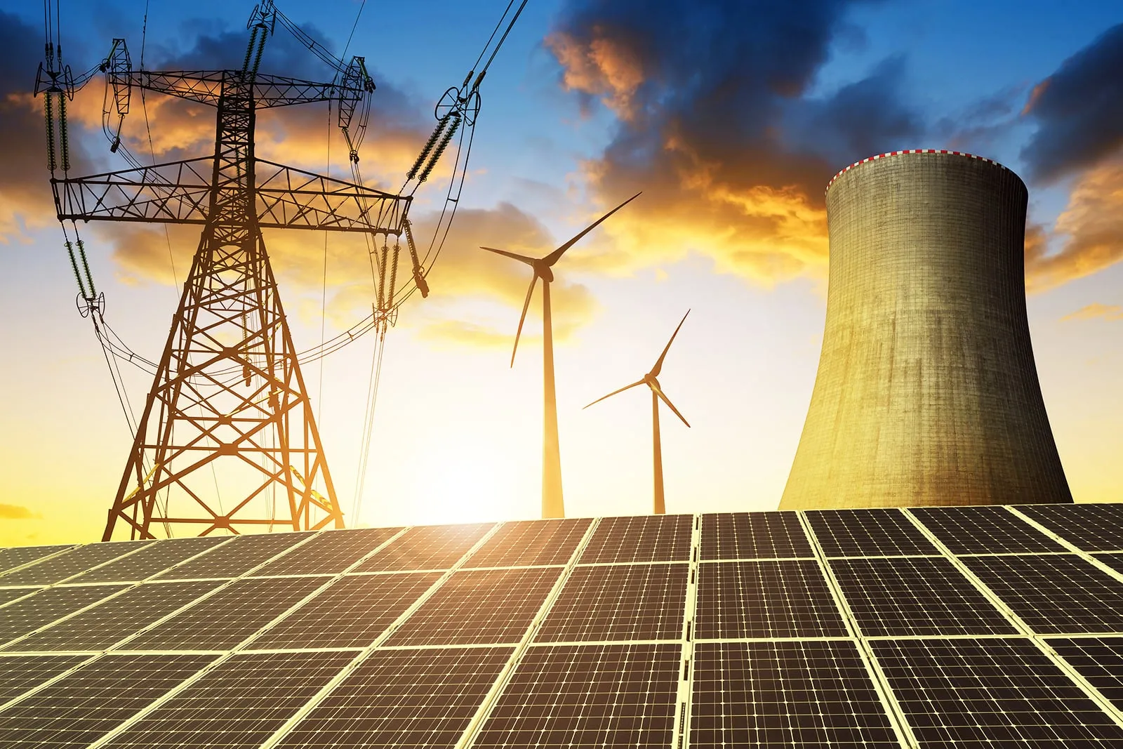 Wind turbines, solar panels and a power pylon at sunset.