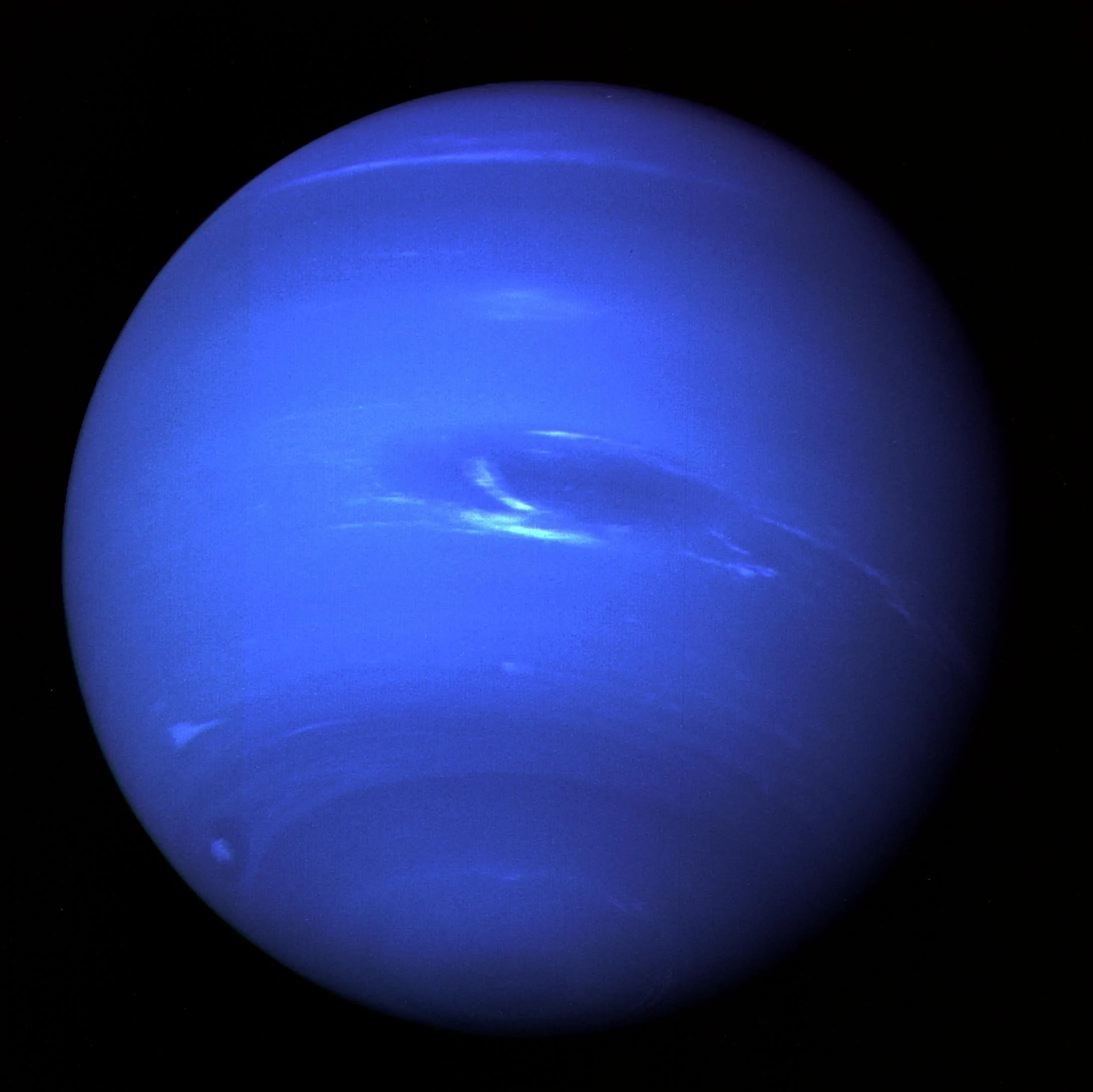 Neptune, a deep blue globe with a dark storm.