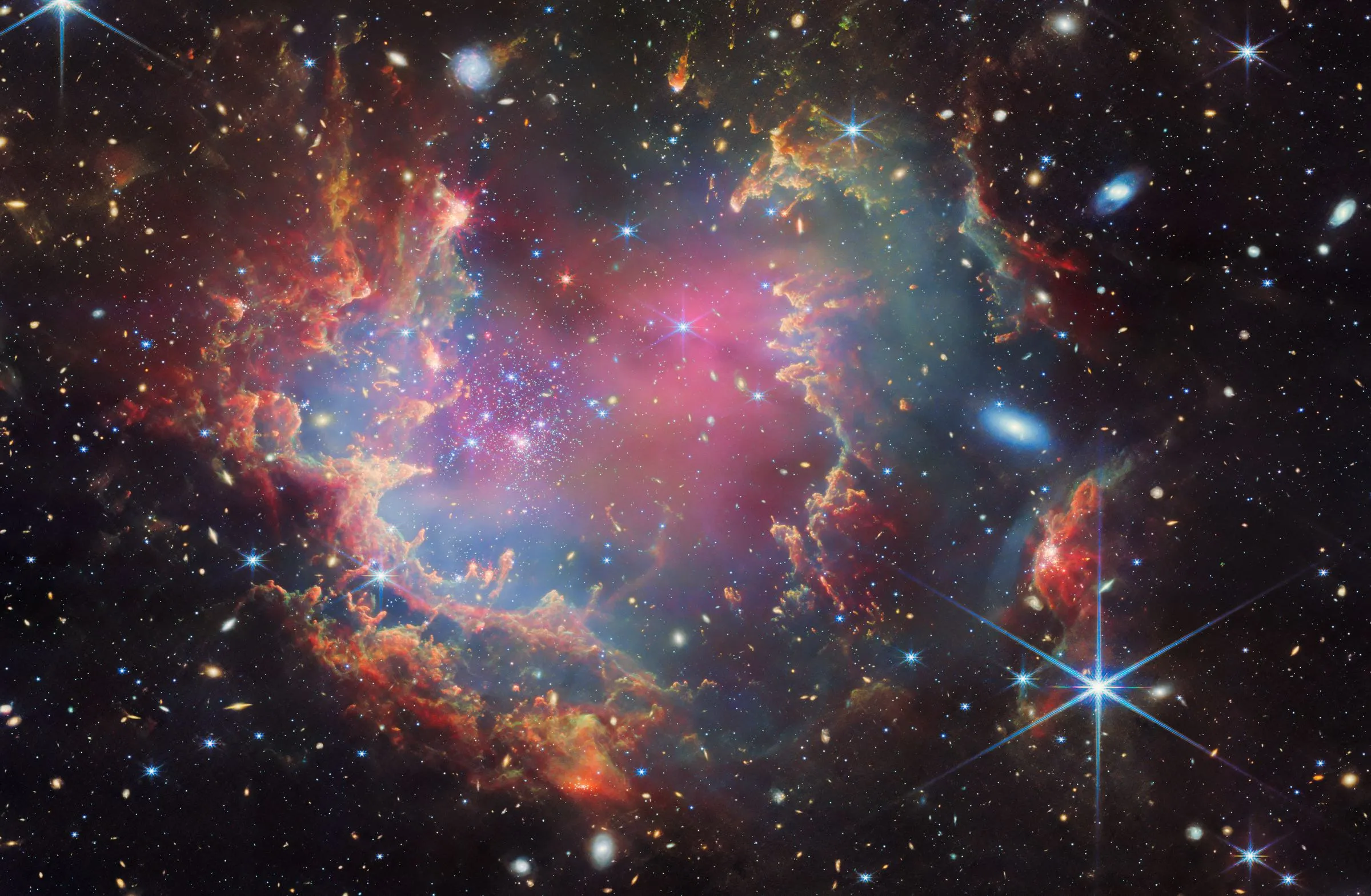 The young star cluster NGC 602 inside clouds of gas and dust, imaged by the James Webb Space Telescope.