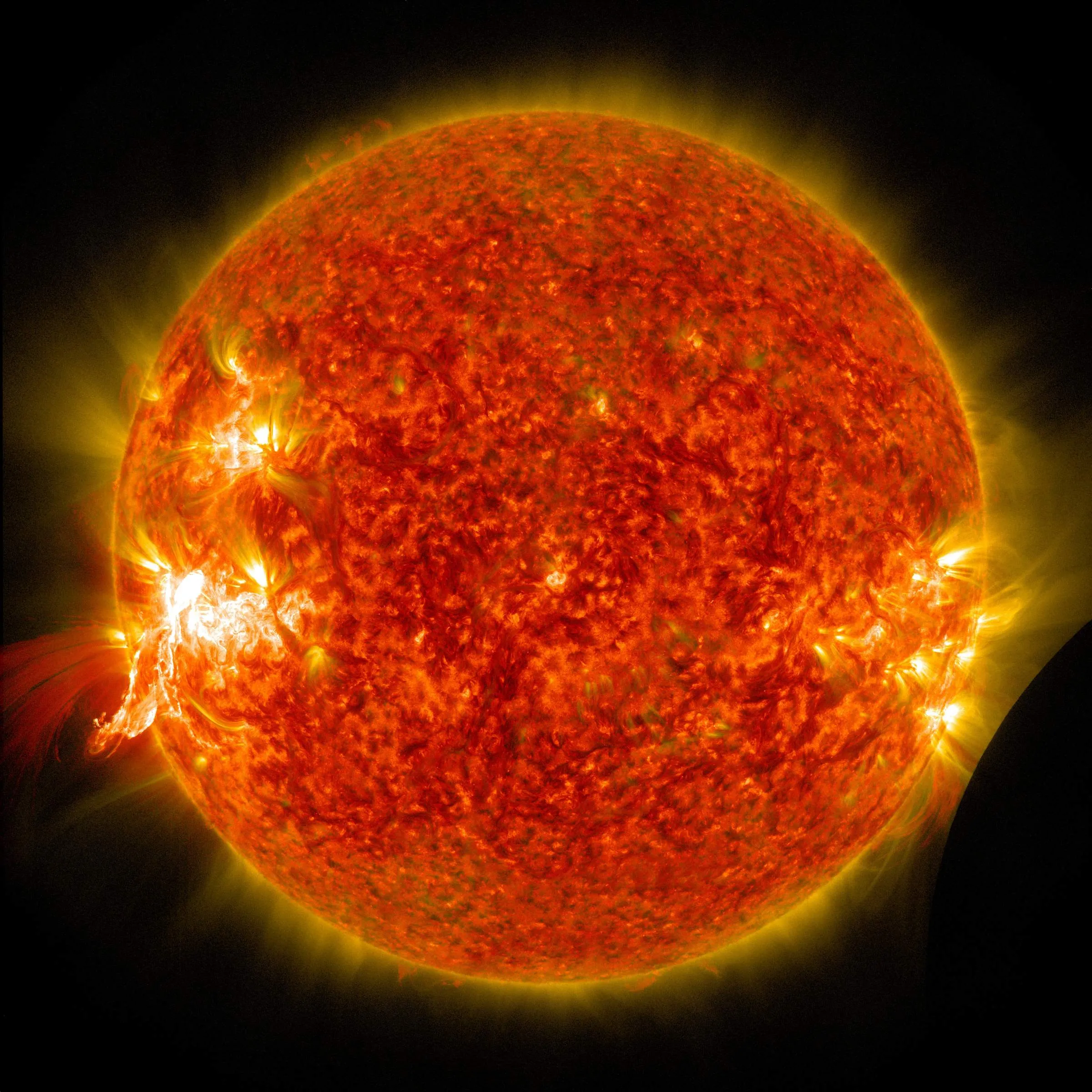 The Sun glowing orange with bright active regions.