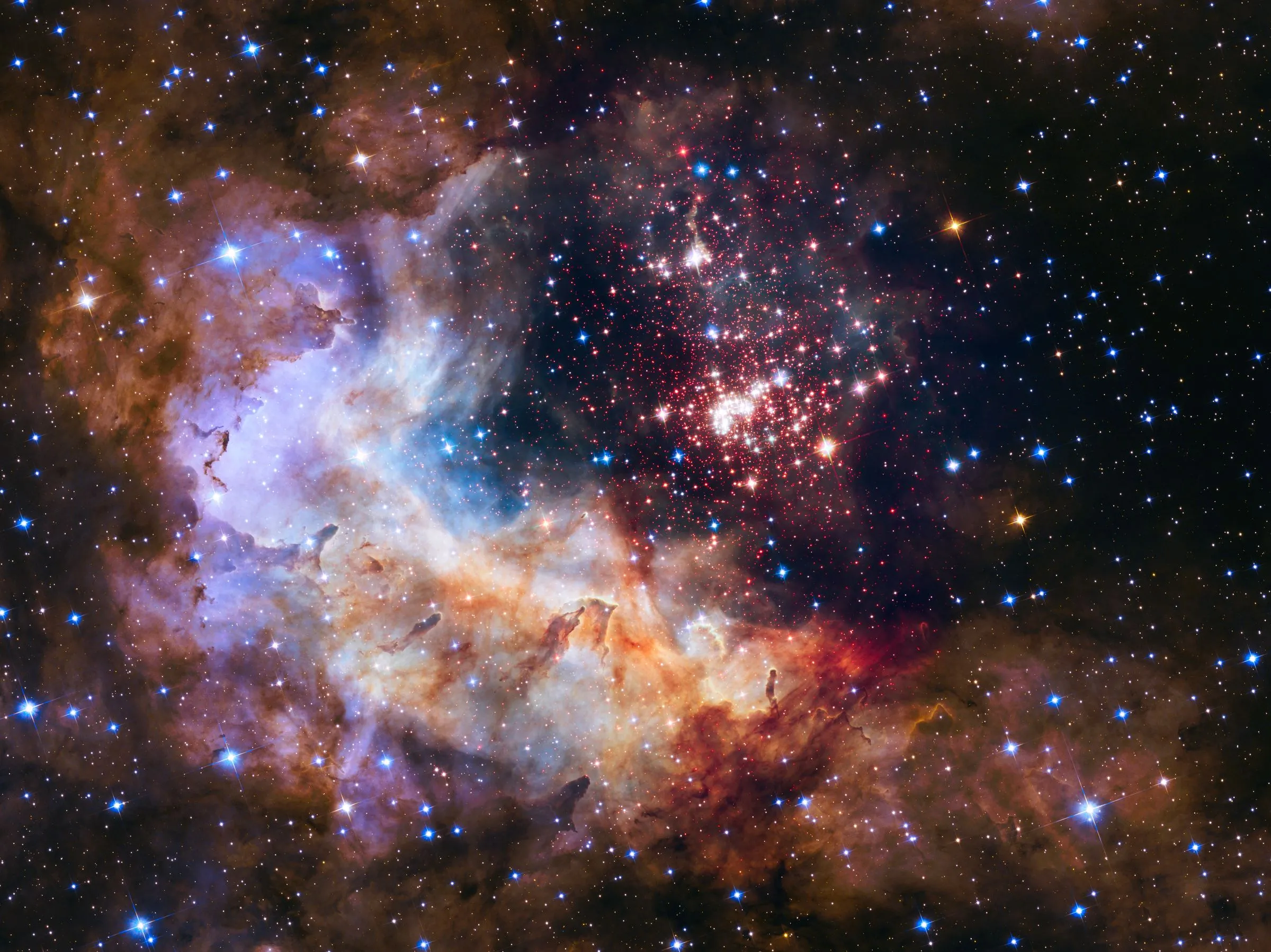 The star cluster Westerlund 2 inside glowing clouds of gas and dust.